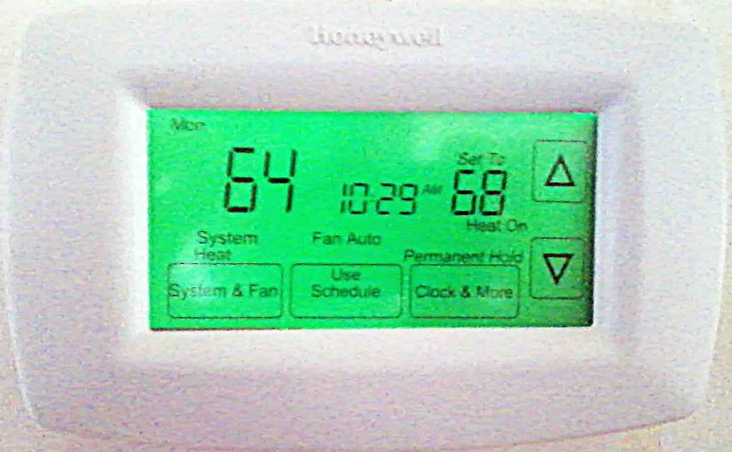 Picture of an installed and operating RTH7600D Programmable Thermostat by Honeywell.