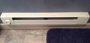 Picture of a typical installation of an electric baseboard heater in bathroom.