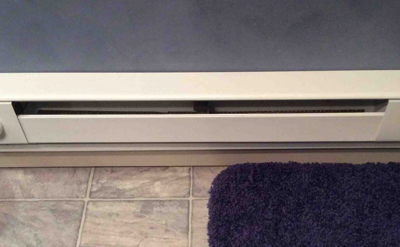 Picture of a typical installation of an electric baseboard heater in bathroom.