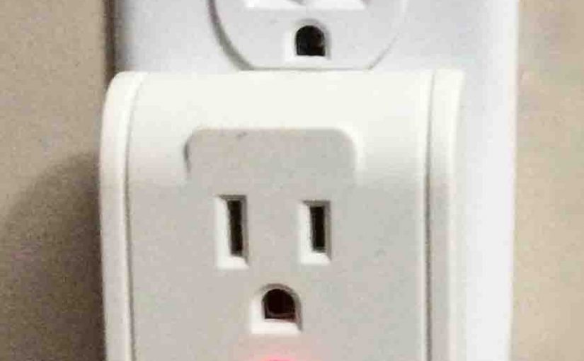 Picture of the Utilitech Single Outlet Surge Protector, Front View, plugged In and operating.