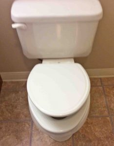 Picture of a Newly Installed No Slam Commode Seat, Showing Seat Lid Slowly Closing.