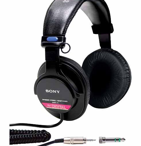 picture of the Sony MDR V6 studio monitor headphones, showing coiled cable, connector, and the headphones.