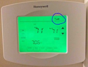 Picture of the Honeywell RTH8580WF Wifi Thermostat, Returned to Normal Operation after successful configuration of a new wireless network, showing the circled wifi status icon in the status area.