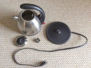 Picture of the Hamilton Beach 40891 stainless steel tea kettle, Disassembled, showing the kettle, strainer, lid, and power stand. How to clean stainless steel tea kettle.