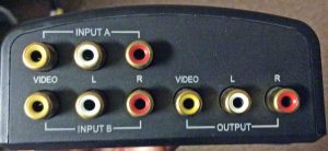 Picture of the Radio Shack 15312 AV Two Input Switch, Back View, showing the three RCA jacks per input (two audio and one NTSC video), and one set of these for the output. 