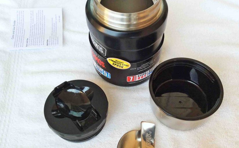 Picture of the Thermos Insulated 16 Ounce Food Jar Completely Disassembled, showing the outer lid, inner cap, spoon and the double walled storage container itself.