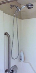 Picture of the Installed Danze D469020 Chrome Shower Hose in a typical bathroom shower tub. 
