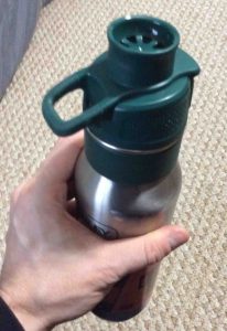 Picture of the Stanley 24-ounce One Handed Hydration Bottle, fitting comfortably into hand. 