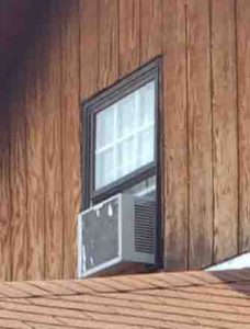 Picture of the rear view of a typical window air conditioner, its hot side.