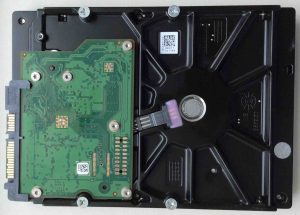 How to recover a hard drive that is clicking. Picture of a Seagate Barracuda SATA 500 GB hard disk drive, bottom view.