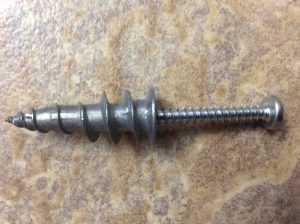Picture of the EZ Ancor Stud Solver wall anchor with screw inserted.