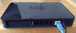 Picture of the rear view of the Netgear WNDR4300 N750 WiFi router. Showing the USB, internet Ethernet, and power ports, and power switch.