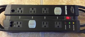Top view picture of the Belkin Isolator Surge Suppressor F5C980-TEL, showing outlets, status lamps, cord keeper, and how the outlets are organized into LEVELS of protection.
