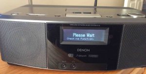 Picture of the Denon S-32 Internet Radio, Displaying the, "Please Wait, Checking Function," message, just after turn-on. 
