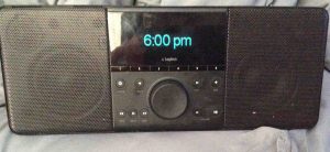 Picture of the Logitech SqueezeBox Boom Internet Radio, in Standby OFF Mode, showing the current time of day on its display.