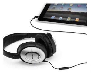 Stock picture of the Bose Quiet Comfort 15 headphones, plugged Into a tablet computer.
