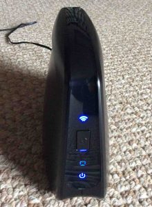 Picture of the Linksys Cisco WES610N Network Bridge. Front View, showing status lamps when connected to a Wi-Fi network. 