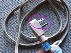 Extension cord safety tips: Picture of tarnished prongs on extension cord plug.
