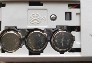 Picture of the open battery compartment of the Sharp El-620 talking calculator, showing proper battery installation. The + sign should be visible on all three batteries. 