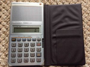 Picture of the Sharp EL-620 voice synthesized calculator, open case, front view.