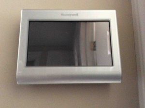 Picture of the Honeywell RTH9580WF Internet Thermostat, mounted but powered down, snapped onto wall plate.