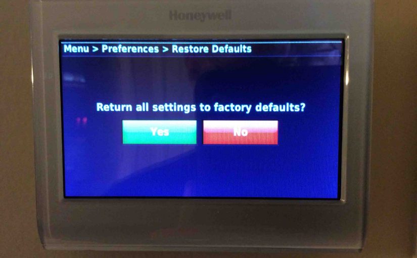 Picture of the Honeywell RTH9580WF Smart Thermostat, displaying the Restore Factory Defaults confirmation screen.