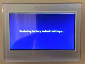 Picture of the -Restoring Factory Default Settings- screen that displays during reset. Honeywell RTH9580WF thermostat reset.