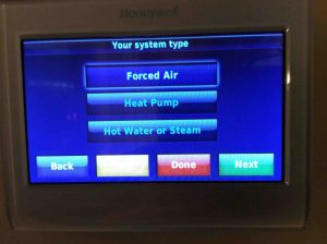 Picture of the Honeywell RTH9580WF WiFi smart thermostat, displaying the Your System Type screen. 