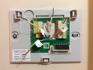 Picture of the t-stat model RTH9580WF wall plate, mounted, but with wires not yet connected.