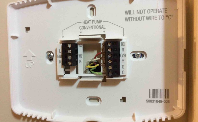 Picture of a Honeywell WiFi thermostat wall plate, showing a typical wiring hookup.