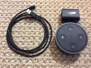 Picture of the Amazon Alexa Dot 2nd Gen with adapter and USB cable. Alexa features list. 