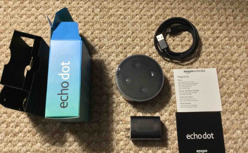 Picture of the Amazon Echo Dot 2nd Gen speaker, original package, with Items inside unpacked.