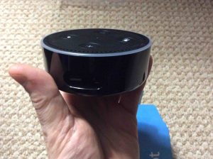 Picture of the Echo Dot 2nd generation speaker, out of box, with protective plastic removed. Currently powered off, but ready for plugin. 