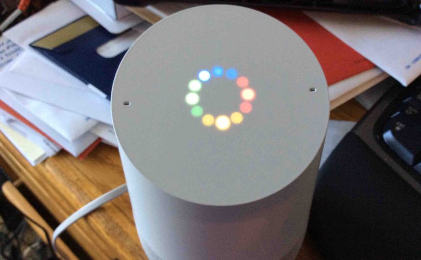 Picture of the Google Home speaker, booting in progress, displaying the multi colored light ring, indicating that.