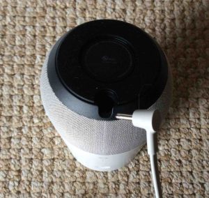 Picture of the Google Home speaker, bottom view, showing the 16.5 Volt DC barrel style power connection.