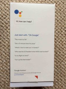 Picture of the Google Home speaker, original box, left side view. 