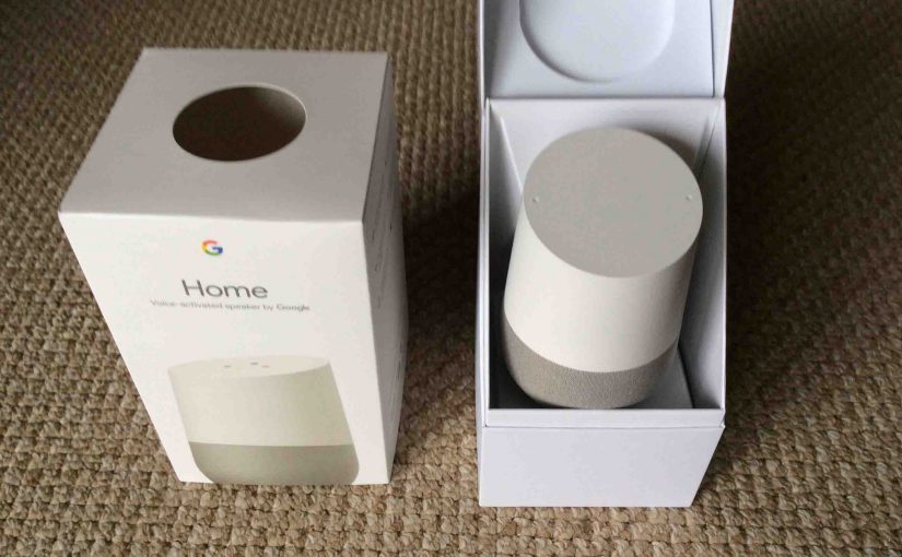 Picture of the Google Home smart speaker, front view, with box open.