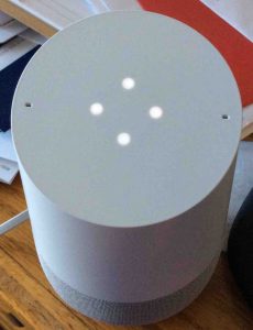 Picture of the Google Home speaker in setup mode, displaying four white dots indicating as such.