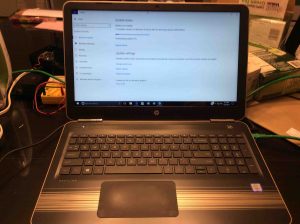 Picture of an HP laptop PC, downloading Windows updates after reboot. Power Off Computer Pros and Cons. 