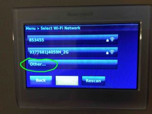 Picture of the Honeywell RTH9580WF thermostat, displaying the Select WiFi Network screen, with the Other... option highlighted. 