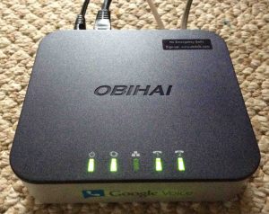 Picture of the Obihai OBi202 VoIP Phone Adapter, showing the top and front while operating.
