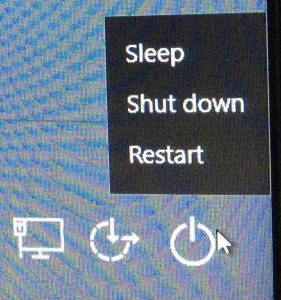 Picture of the Windows 10 logon screen, showing the Power button menu.