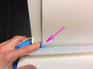 Picture of the HP DeskJet 3632 printer, showing adjusting of the blue paper width guide. How to Install HP DeskJet 3630.