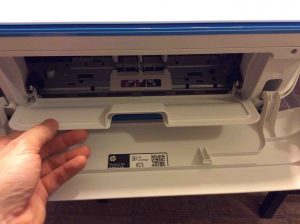 Picture of the printer, front view, showing inner access door being opened.