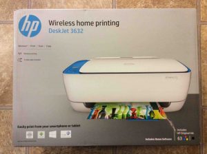 Picture of the printer in its box, showing the box front view. Unboxing HP DeskJet 3632.