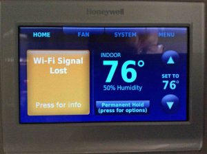 Picture of the Honeywell wireless thermostat, displaying its -Lost Wi-Fi Signal- message.
