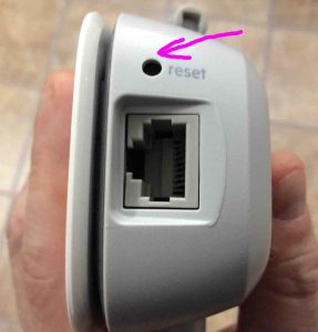 Picture of the Belkin F9K1122v1 wireless range extender, bottom view with the reset button location highlighted.