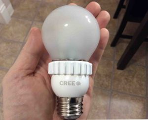 Picture of the Cree™ 60w LED daylight 5000k dimmable A19 light bulb, held in hand.