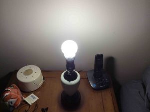 Picture of the 5000k bulb, operating in bedroom lamp, with the shade removed.