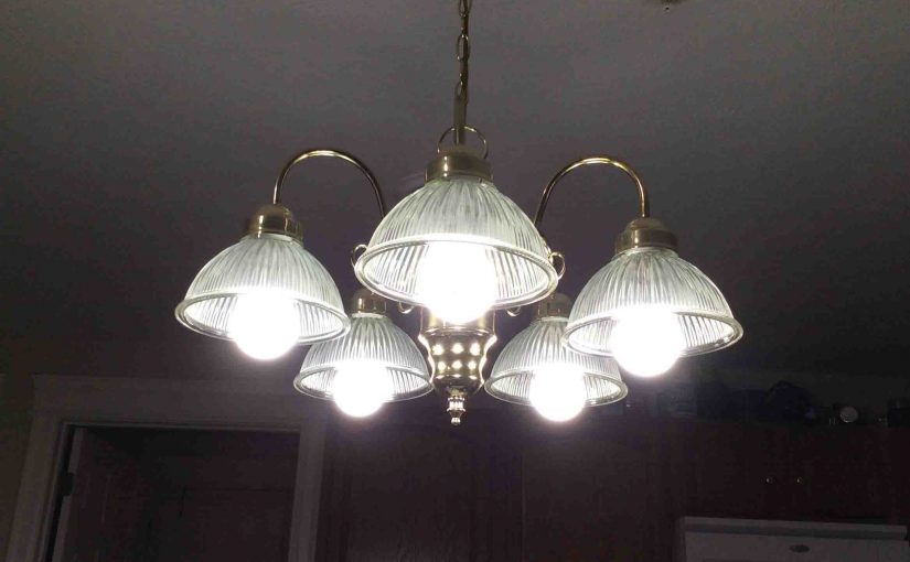 Picture of five Ecosmart™ LED 60w A19 daylight white light bulbs, operating in dining room chandelier.
